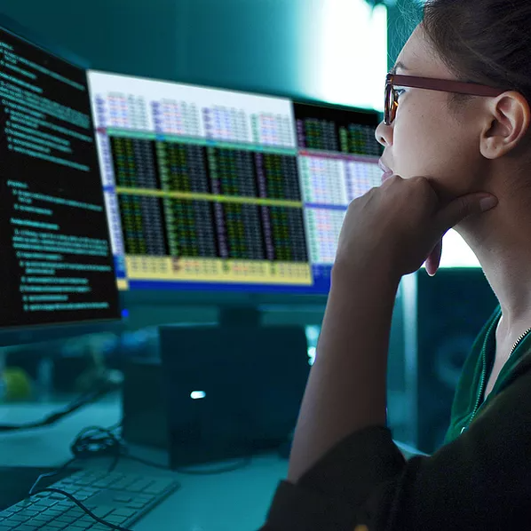 A woman looking at charts on the screen