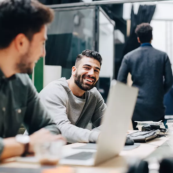 Microsoft Intune enables employees in an office to collaborate seamlessly and securely by ensuring their devices and apps are properly managed, protected, and compliant with company policies, reducing security risks while enhancing productivity.