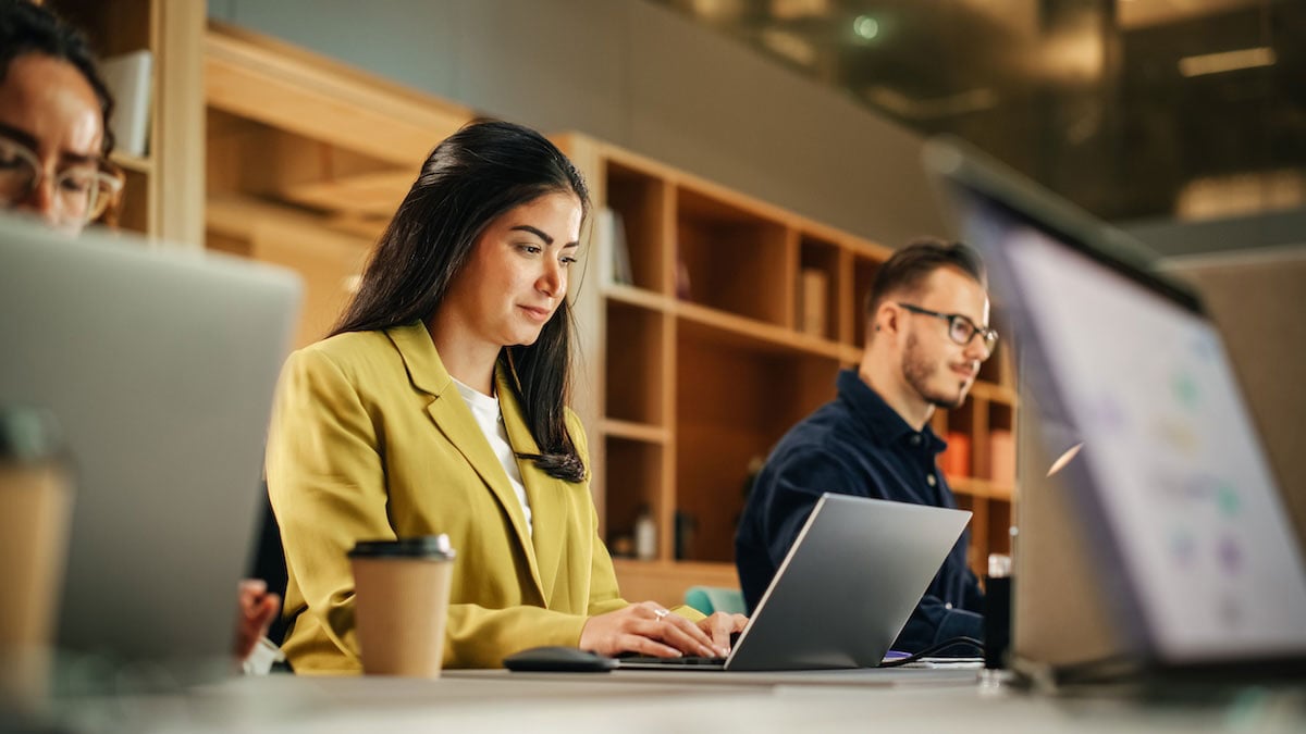 An account executive catches up on emails and prepares statements of work for clients, showing how deal details outside the CRM affect pipeline accuracy.