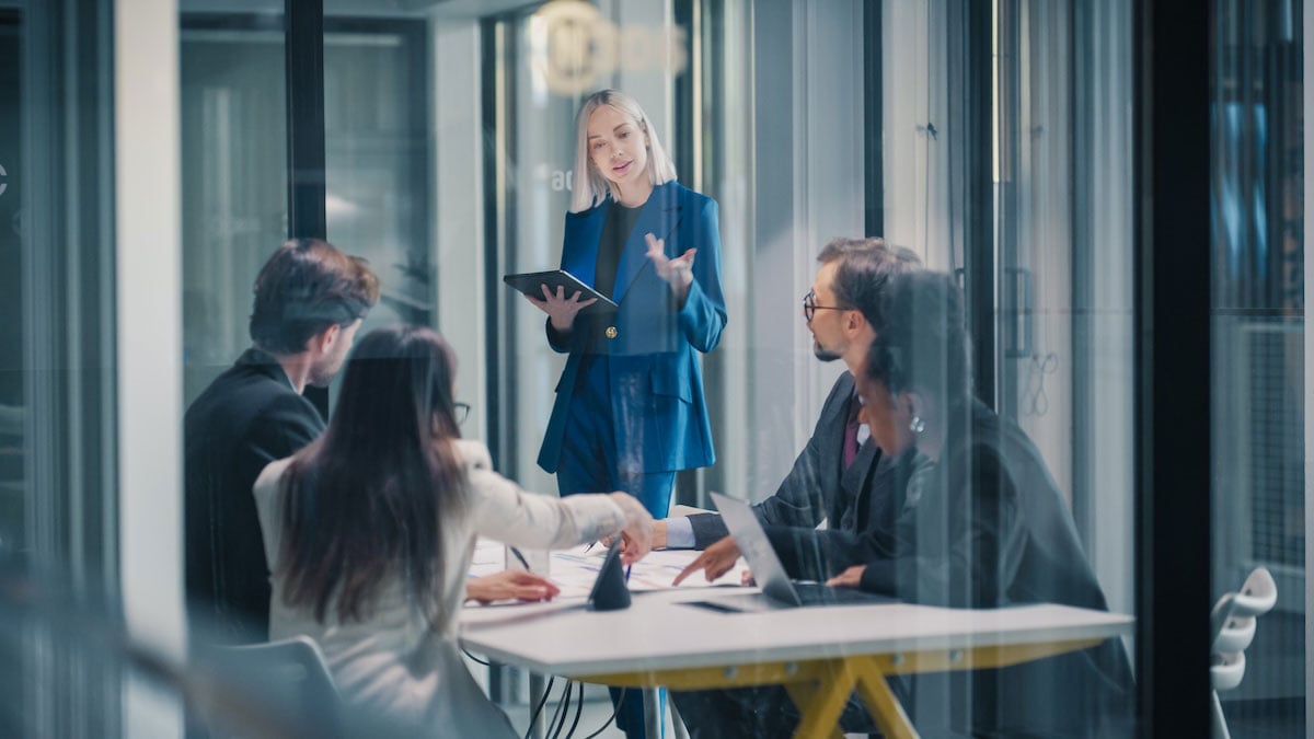 A VP leads an all-hands meeting for her department, where important updates and customer signals can come up that executives need to see.
