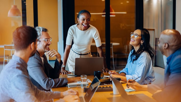 A CMO stands before her marketing team to present, illustrating how leaders can deliver personalization at scale through trusted data and AI governance.