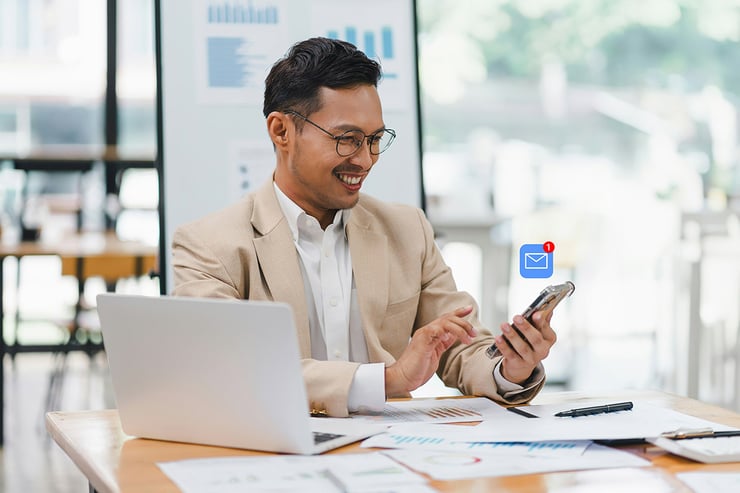 An analyst easily sorts and accesses categorized emails on his phone through Microsoft 365, enabling him to stay organized and quickly locate client communications while on the go
