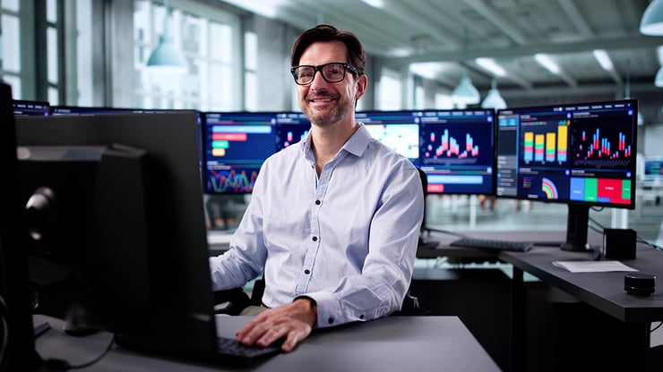 A COO working on a laptop, representing the need for clear governance, visibility, and accountability when managing AI agents across business operations.