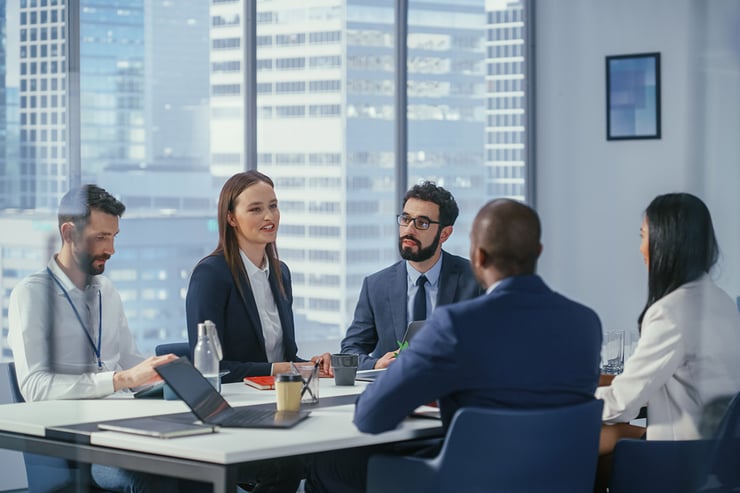 Business leaders meeting to evaluate AI pilot results and define the outcomes, governance, and roadmap needed to move AI into production.