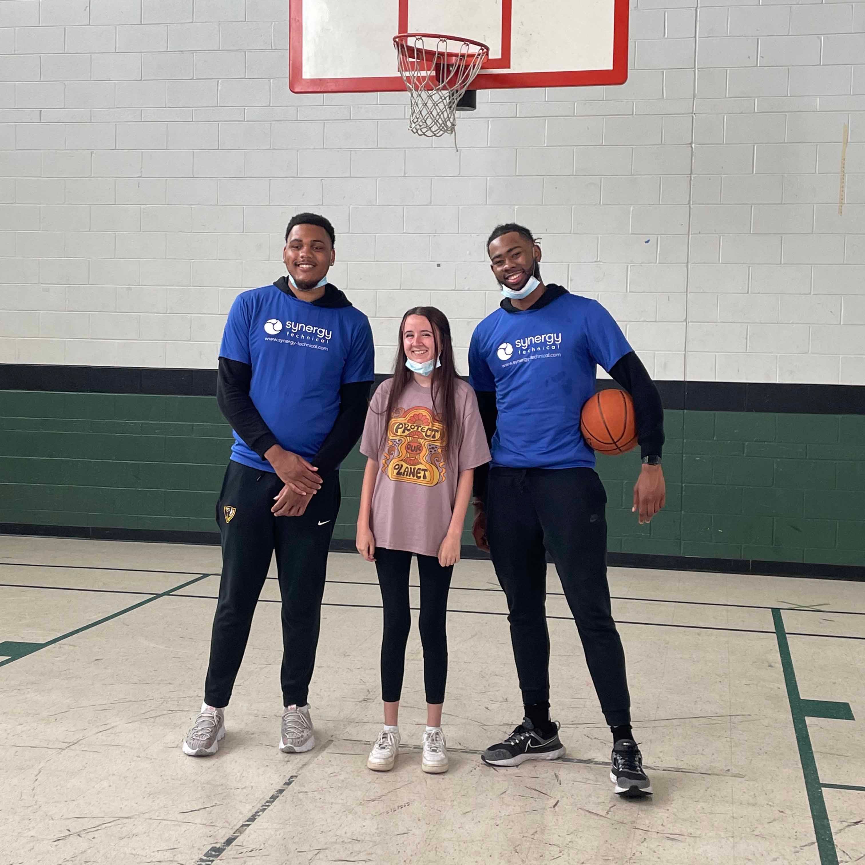 Synergy Technical and kid posing with basketball