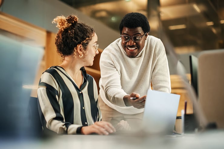 During a rebrand, an employee continues collaborating with internal teams and external partners because Microsoft 365 changes were planned to preserve domains, links, and workflows.