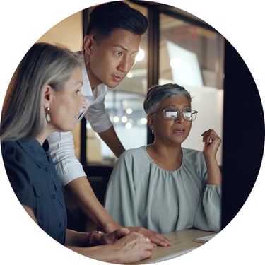 A male IT director reviews his team’s desktop alongside two coworkers, using Microsoft Agent 365 to monitor AI agents, understand activity, and maintain stronger control across the organization.