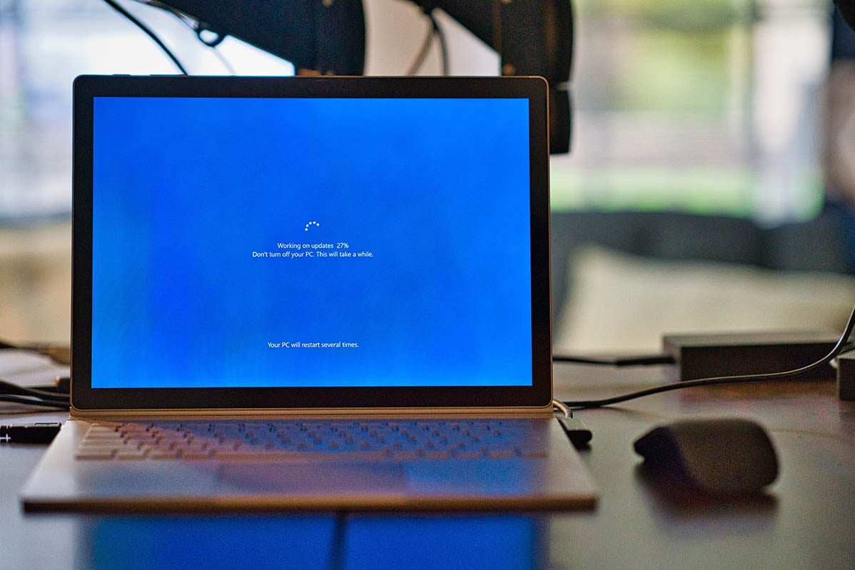Picture of a Microsoft Surface Laptop displaying Windows going through an update