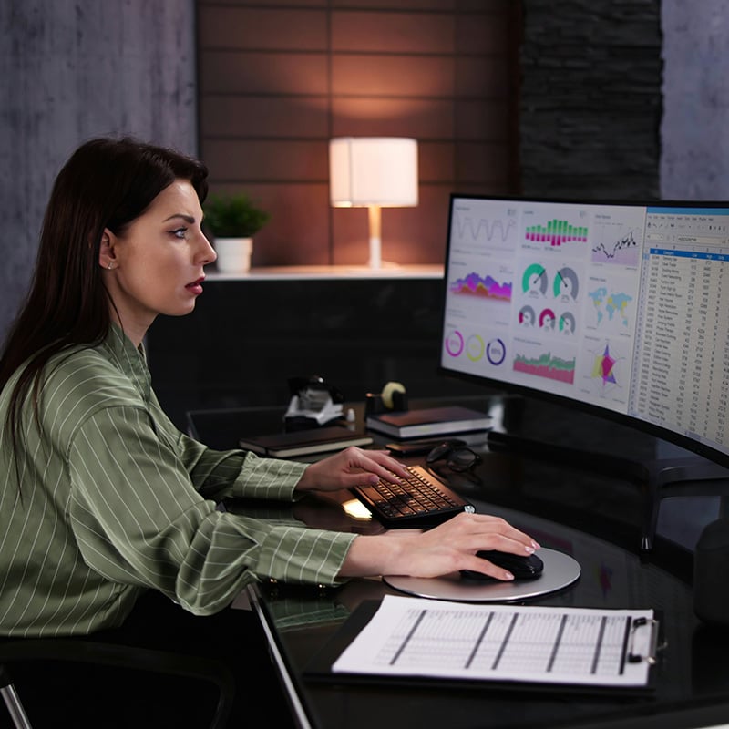 A risk management analyst confidently examines sensitive datasets in Microsoft Fabric, supported by Purview Information Protection and Data Loss Prevention policies that safeguard client privacy and prevent misuse.