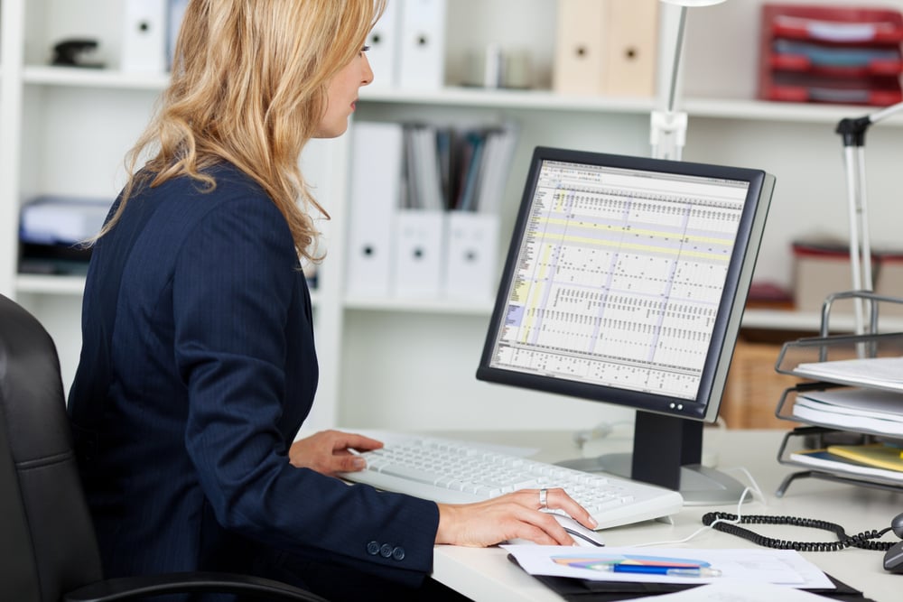 Employee using computer at office to access sensitive customer data