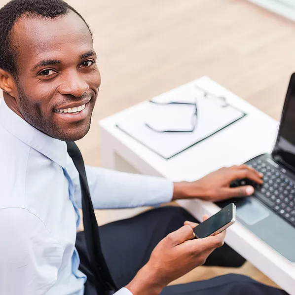 Smiling Man on Laptop