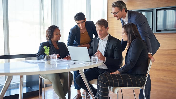 Marketing team members review business insights together as Microsoft Copilot Cowork helps streamline collaboration and decision-making.
