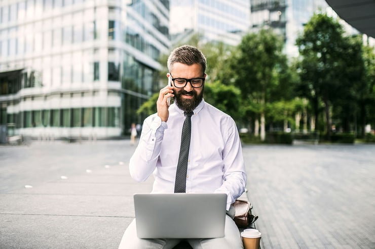A CTO taking a meeting outside during his business trip showing the flexibility the Microsoft CSP delivers for organization's like his.