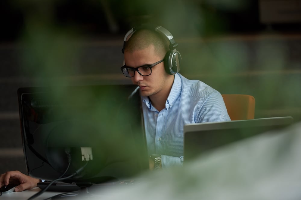 IT employee working on computer at modern office