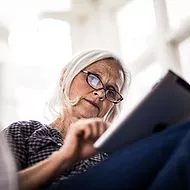 A woman reading on her tablet device-2
