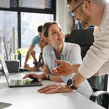 Picture of employees using SharePoint to share resources and news with other people in the organization