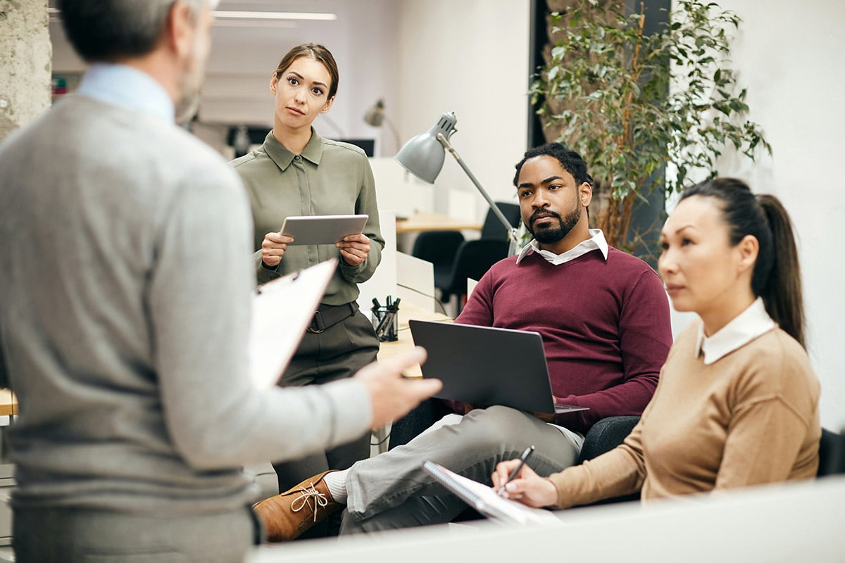 A consultant from Synergy Technical is collaborating at a computer, analyzing real-time data and system logs to assess his client’s environment and develop a tailored Business Continuity and Disaster Recovery plan that addresses vulnerabilities, enhances recovery strategies, and ensures compliance with industry regulations.