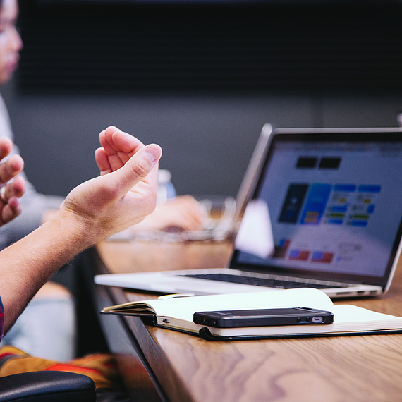 A male employee gestures while video calling his coworkers on Microsoft Teams, benefiting from Microsoft Entra Conditional Access, which ensures secure access by verifying user identity, enforcing device compliance, and applying real-time risk-based authentication to protect sensitive conversations and data.