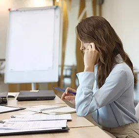 A female remote employee securely accesses corporate data from her laptop, with Microsoft Entra ID’s Multi-Factor Authentication providing an extra layer of security by verifying her identity through a secure second factor, ensuring safe and seamless access to sensitive company resources from anywhere.
