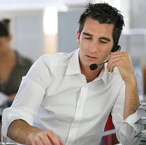 A Synergy Technical managed IT services team member assists a client over the phone, providing expert guidance and quick problem-solving, ensuring minimal disruptions and keeping operations running smoothly.