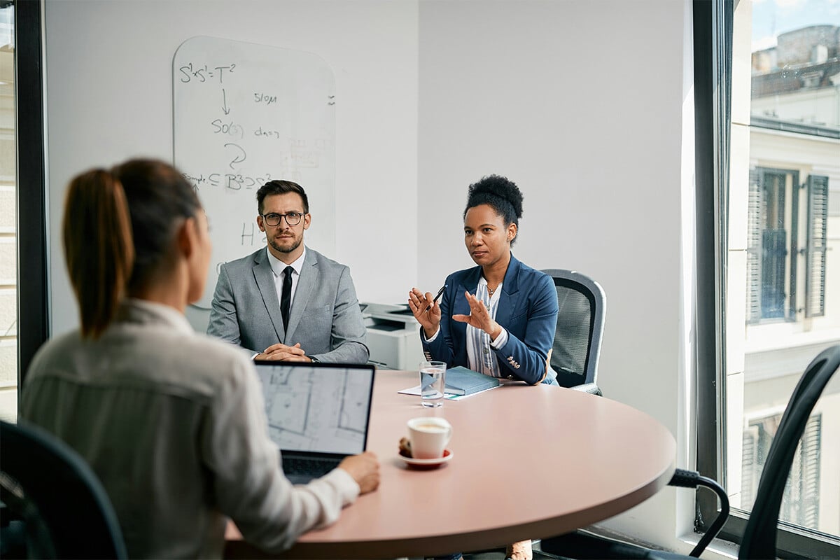 IT stakeholders from a large law firm are meeting with Synergy Technical's consulting team to discuss how they can securely and smoothly migrate their on-premises IT infrastructure to a cloud environment.