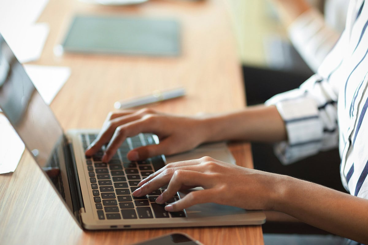 An IT consultant from Synergy Technical leads a collaborative discussion with a client, asking targeted questions to assess their cloud privacy and data security environment.