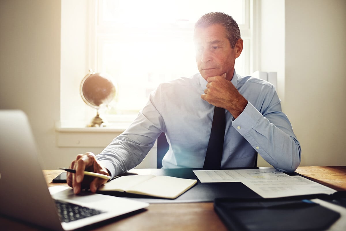 A male employee at a fintech firm is on a call with his team, communicating and sharing files through cloud apps.