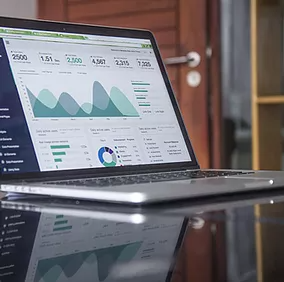 A laptop displays a centralized view of detections, impacted assets, automated actions, and related evidence within the Microsoft Defender XDR portal, providing security teams with a unified, real-time platform to analyze and respond to threats efficiently.