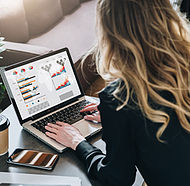 Picture of employee using Power BI in Power Platform to share datasets to coworkers through Teams for a project