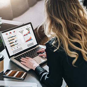 A woman works on her laptop with Office 365 malware protection, benefiting from real-time threat detection that blocks harmful files before they can compromise her organization.