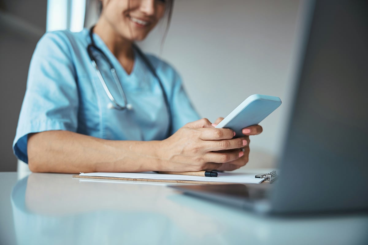 In a busy hospital, a nurse works on her desktop with confidence knowing an IT support staff from Synergy Technical's MSP IT is always available to assist.