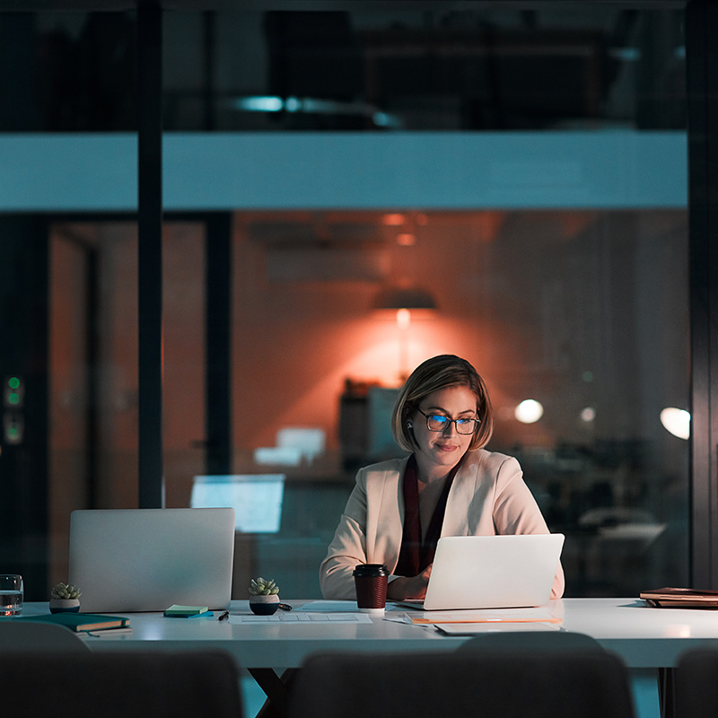 A female CIO uses Microsoft Agent 365 to understand which AI agents are running across the business, giving leadership a clearer view of adoption, risk, and operational impact.