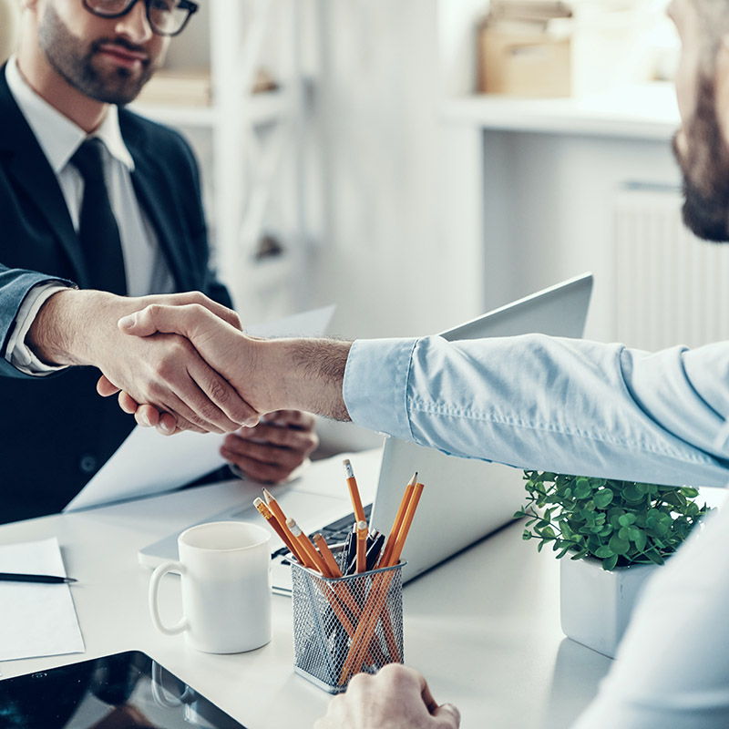 Picture of employee showing up to a clients office prepared and ready to discuss upcoming projects thanks to Copilot in Teams summarizing key actions and discussion points ahead of the meeting.