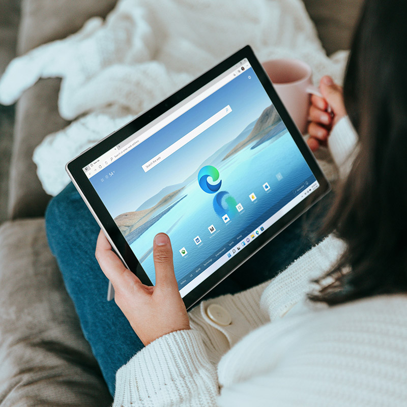 Picture of employee working from home and using Copilot in Microsoft Edge to quickly and efficiently research information for her upcoming bosses speech.