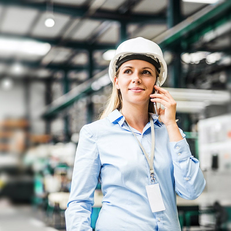 Picture of employee in a distribution facility using Microsoft Copilot in Microsoft Teams to unlock productivity by staying on top of Team chats & messages