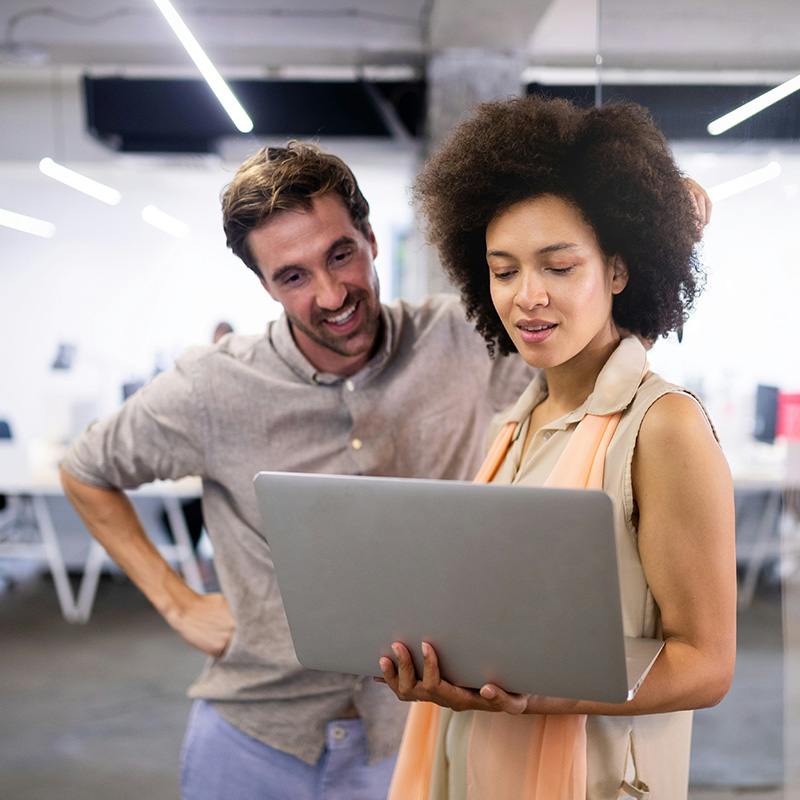A female remote employee securely accesses corporate data from her laptop, with Microsoft Entra ID’s Multi-Factor Authentication providing an extra layer of security by verifying her identity through a secure second factor, ensuring safe and seamless access to sensitive company resources from anywhere.