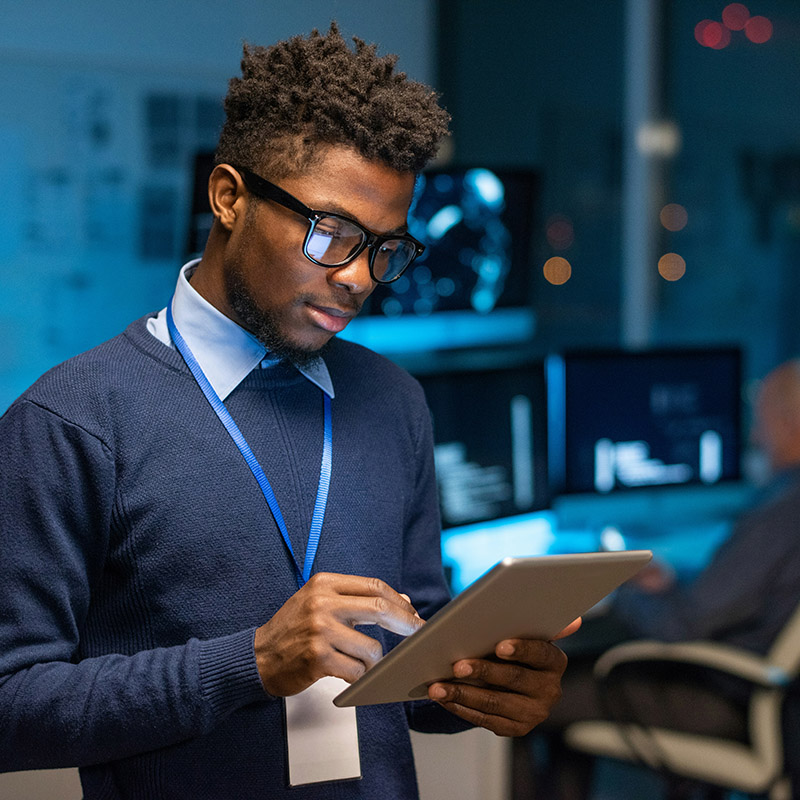 A male employee in the office securely accesses work applications on his mobile device, with Microsoft Entra conditional access dynamically enforcing security policies based on his location, device, and risk level to ensure seamless yet protected access to corporate resources.
