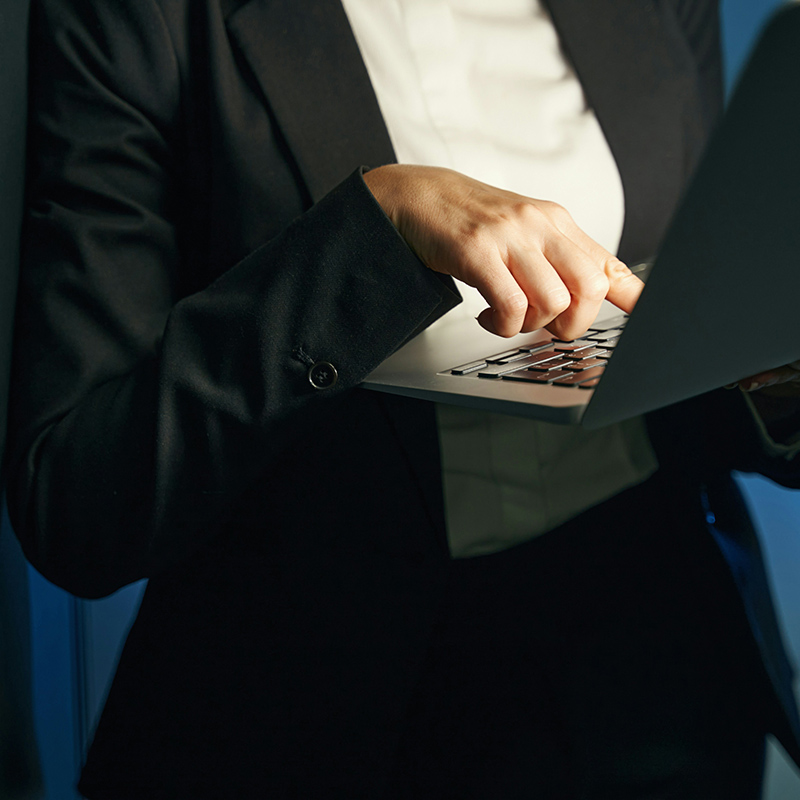 A female business analyst meets to review reports and discuss key findings, with Microsoft Entra Conditional Access ensuring secure access to analytics platforms and data by applying real-time risk-based authentication, role-based permissions, and device compliance policies to protect sensitive business insights.
