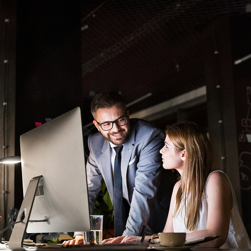 During an investigation, a female compliance officer and her colleague use Purview Audit to identify key indicators like mass downloads, forwarded emails, and unusual logins.
