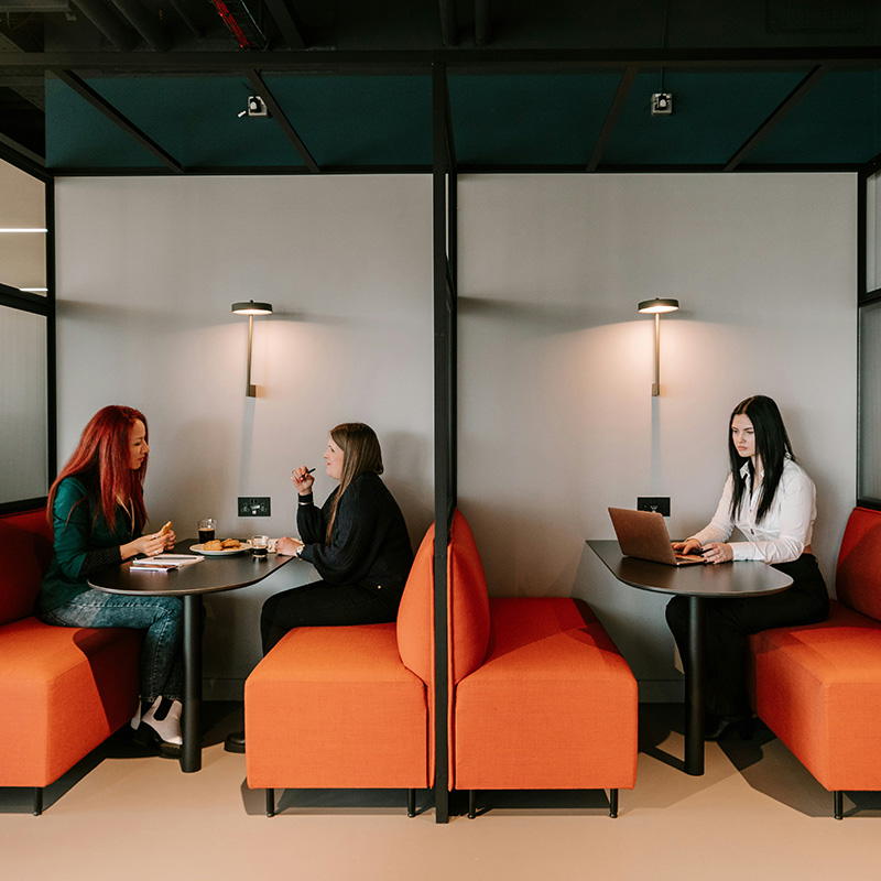 Employees are seen collaborating seamlessly—while Purview Audit maintains quiet oversight to help reduce risk without interrupting how people work.