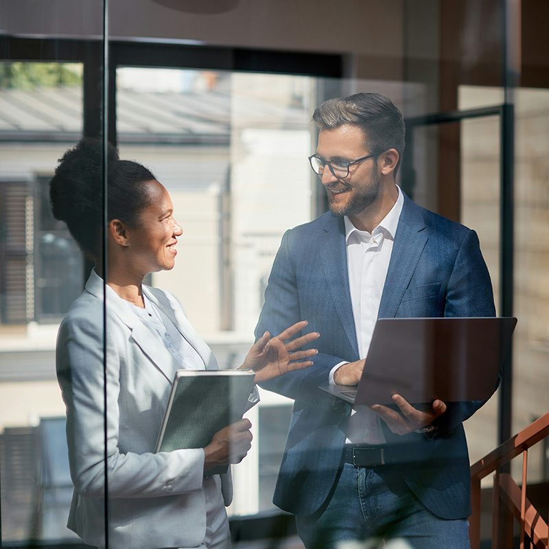 After a client call, two employees apply Microsoft Purview Sensitivity Labels to documents and presentations, enabling them to stay productive without compromising security.