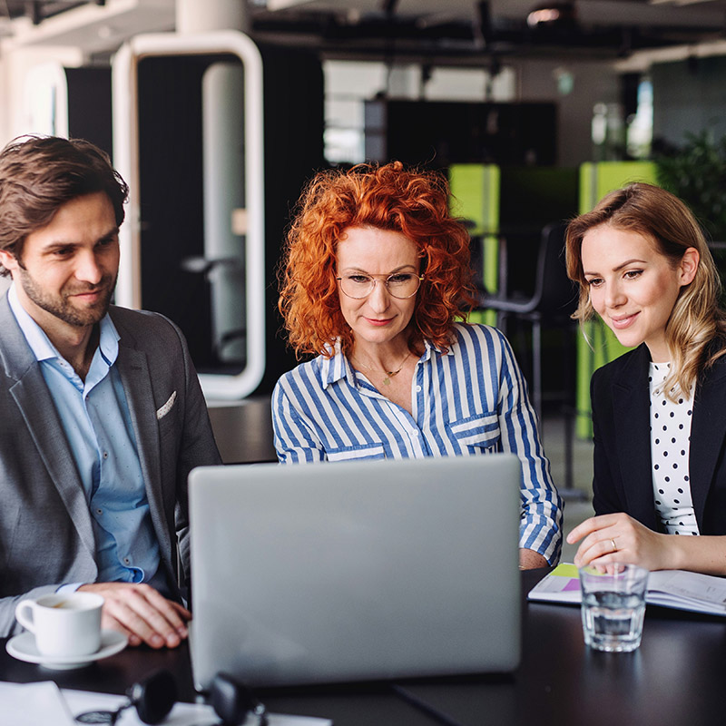 A group of employees prepare for a client meeting with confidence, knowing all shared materials are secured using Microsoft Purview Sensitivity Labels.