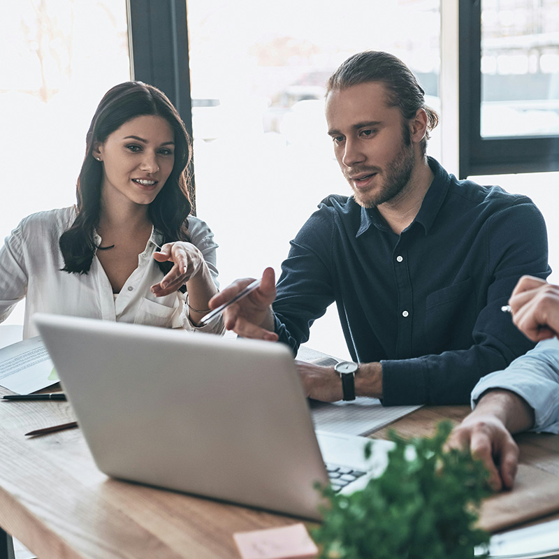 Security analysts gather around a laptop reviewing correlated insights surfaced by Microsoft Sentinel—focusing investigations with context-rich data.
