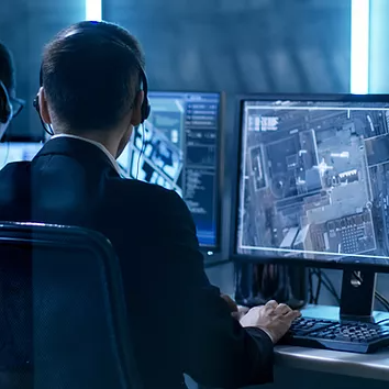 An IT security team monitors Microsoft Entra ID Protection, analyzing real-time sign-in risk alerts and automated threat detection to proactively identify and mitigate potential security breaches before they impact critical applications.