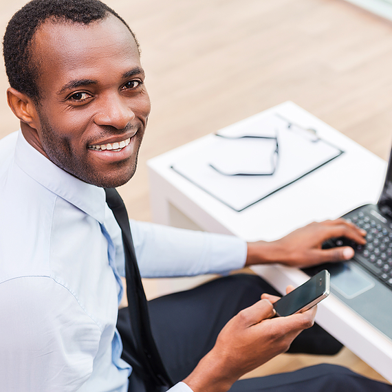 Smiling Man on Laptop