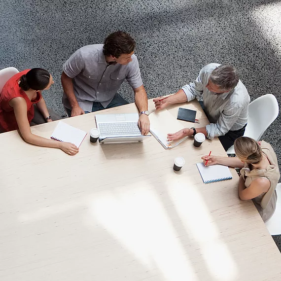 A group of employees collaborates on business applications to complete projects, with Microsoft Entra Multifactor Authentication securing their access, preventing unauthorized logins, and ensuring sensitive company data remains protected.
