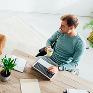 A male marketing agency employee works remotely, securely accessing Microsoft 365 applications like Outlook with Microsoft Defender for Office 365 providing advanced email protection, keeping his communications safe from cyberattacks.