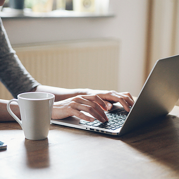 Picture of employee using Exchange Online through her laptop to schedule upcoming client calls and boost sales