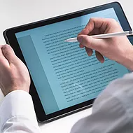 Picture of employee using Word in Microsoft 365 to create impressive documents and improve writing with built-in intelligent features like Microsoft Editor and Researcher